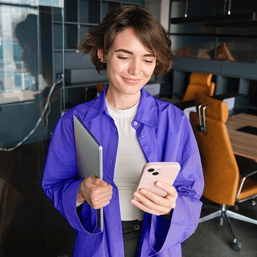 a woman with Apple devices, laptop and phone