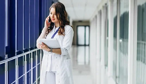 Proget mobility management for the medical industry: doctor holds records and talks on the phone
