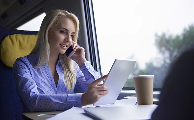 businesswoman talking on her cell phone on a train