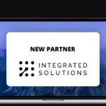 A banner showing a laptop screen with the Integrated Solutions logo and the text “New Partner”