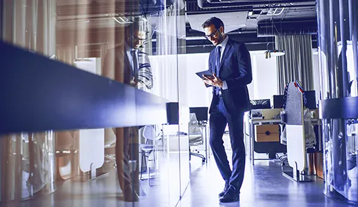 Mobility management project for the financial sector, a man holding a tablet, wearing a suit, a modern office