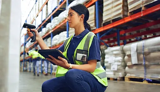 Proget mobility management for transportation and logistics; a woman with a tablet and a scanner in a warehouse